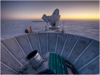 The sun sets behind BICEP2 (foreground) and the South Pole Telescope (background).  <i>Credit: Steffen Richter, Harvard University</i>